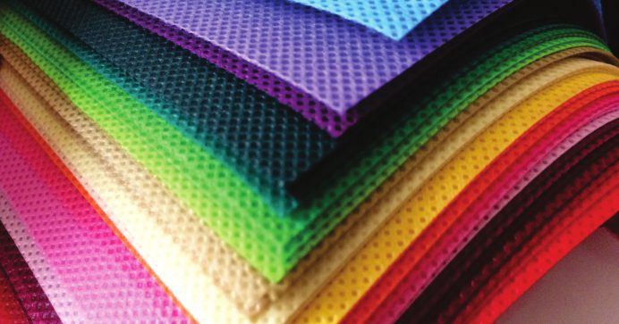 Stacked sheets of coloured non-woven fabric
